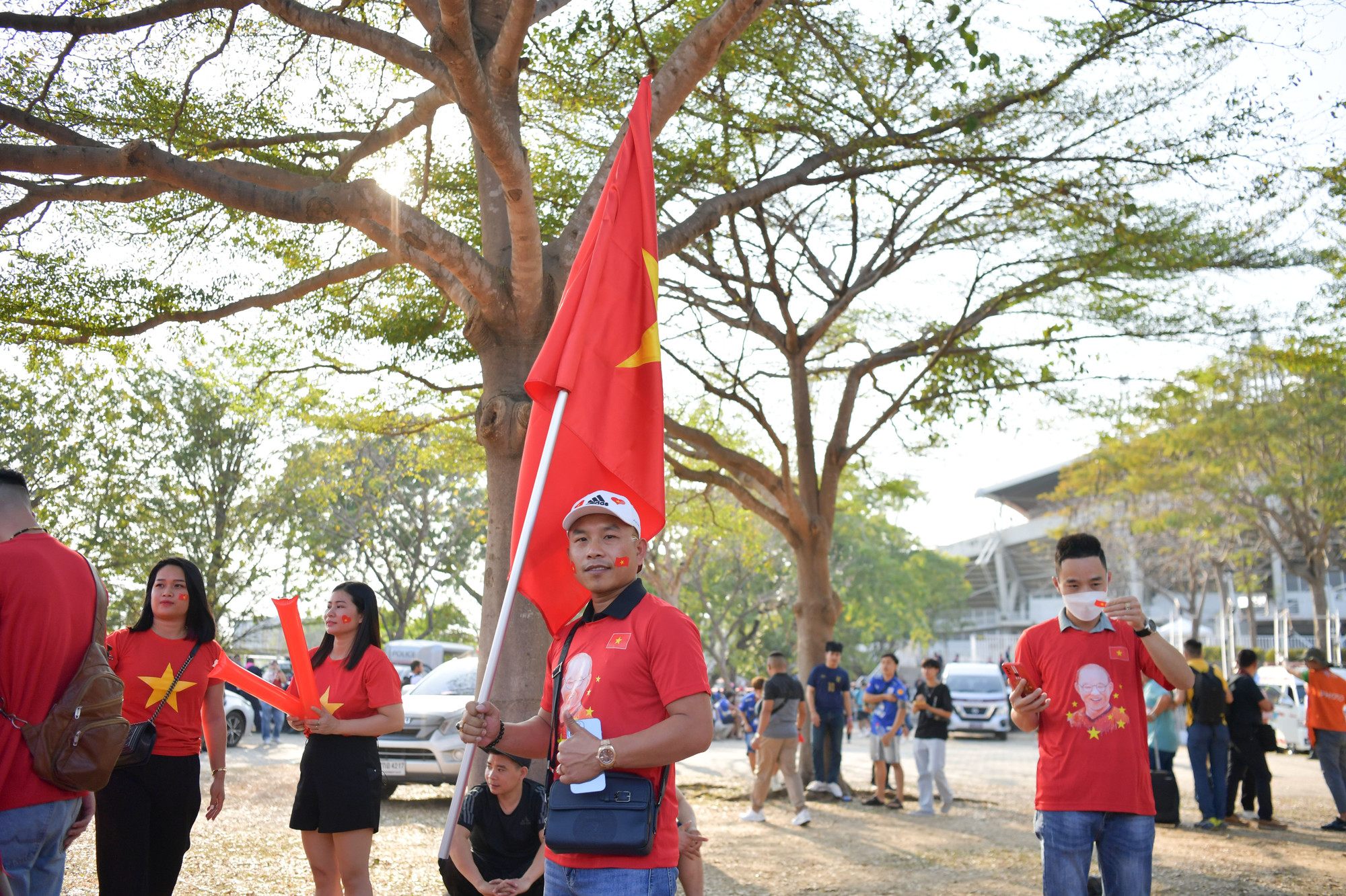 Các cổ động viên mặc áo đỏ và chuẩn bị sẵn cờ tổ quốc để cổ vũ trong trận đấu.