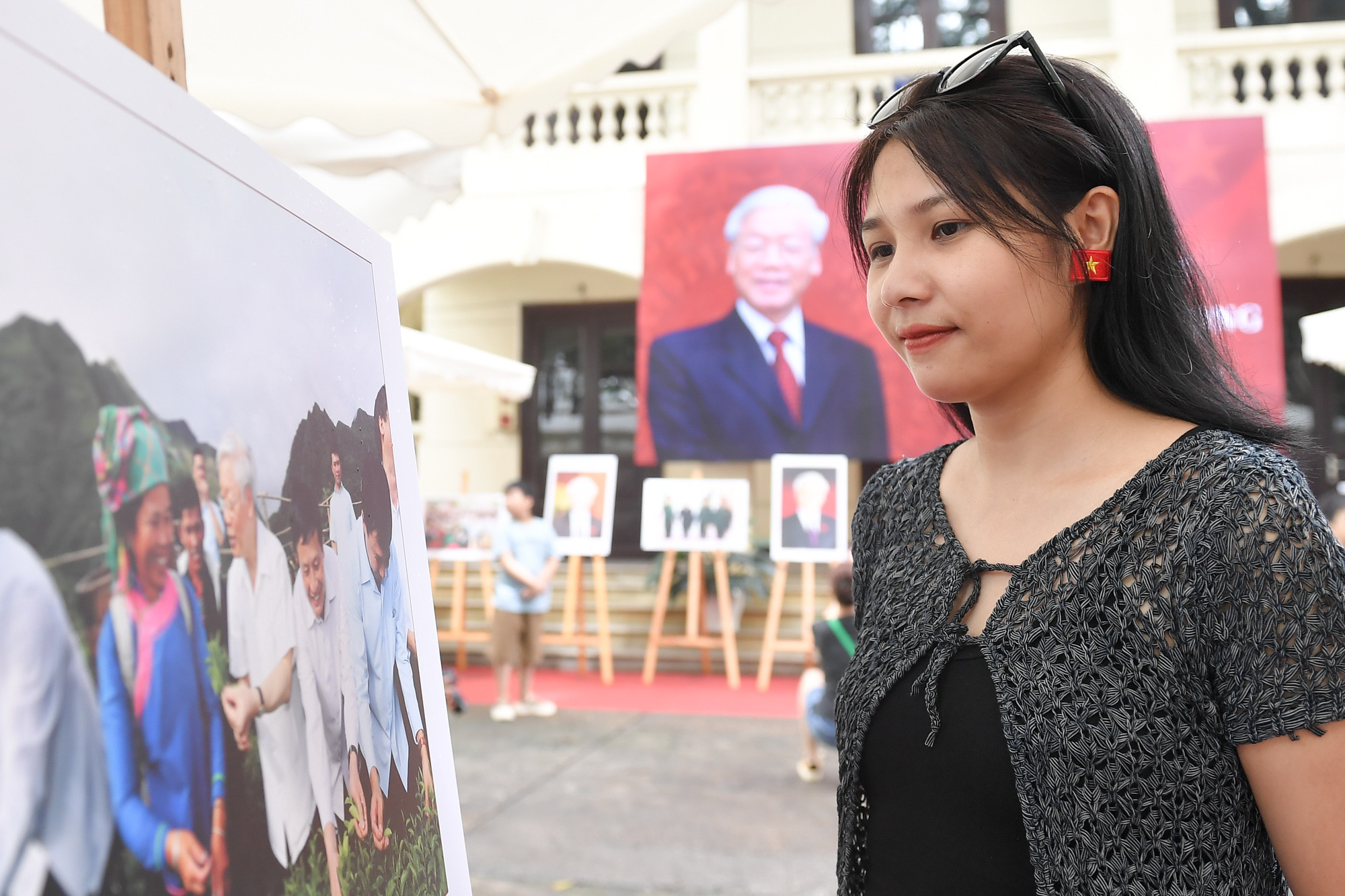 Các bạn trẻ còn đeo những trang sức, trang phục hình lá cờ Tổ quốc để tham quan Triển lãm ảnh Tổng Bí thư Nguyễn Phú Trọng.