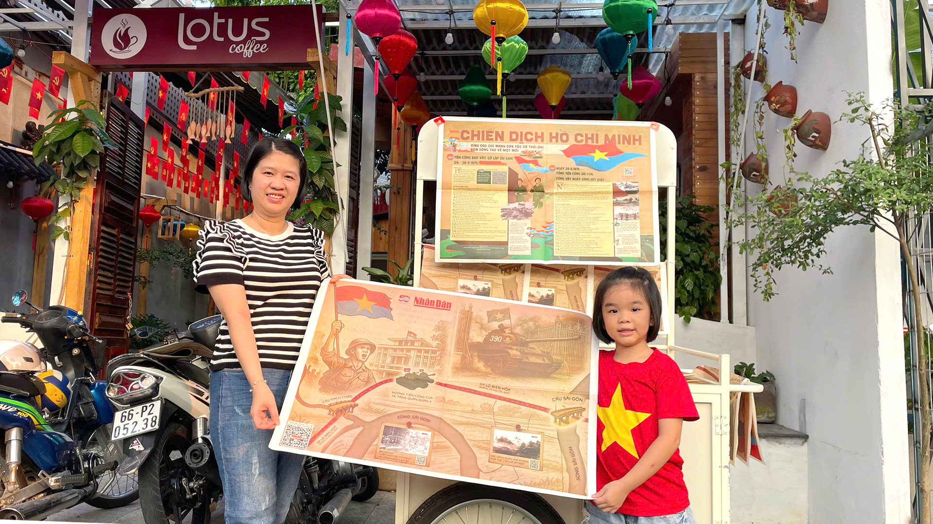 Hai mẹ con vui mừng chụp ảnh lưu niệm khi có được tờ phụ san. (Ảnh: HỮU NGHĨA)