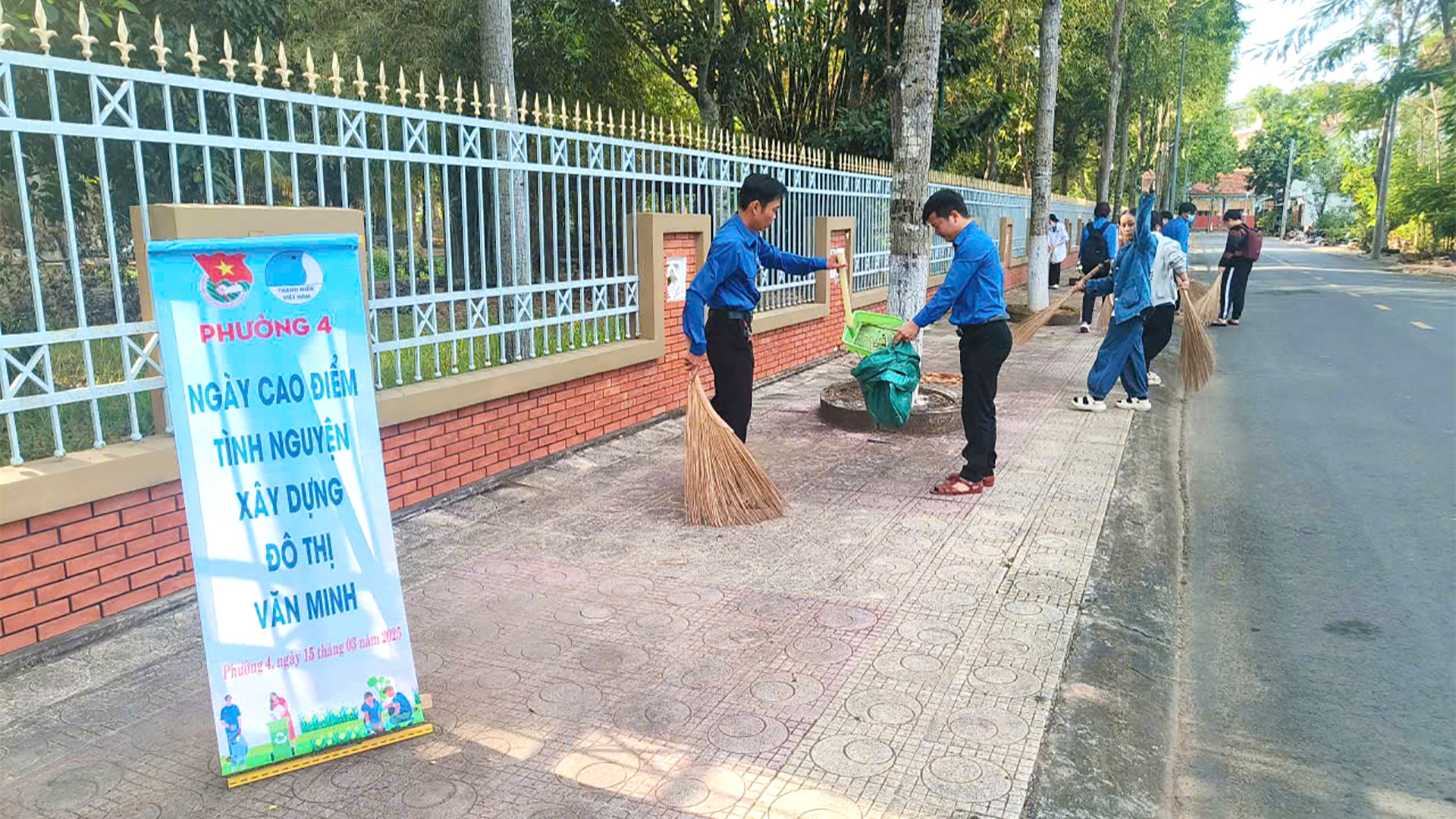 Đoàn viên-Thanh niên thành phố Cao Lãnh dọn dẹp vệ sinh bên ngoài Khu di tích Nguyễn Sinh Sắc tại phường 4, thành phố Cao Lãnh. (Ảnh: NHƯ ANH)