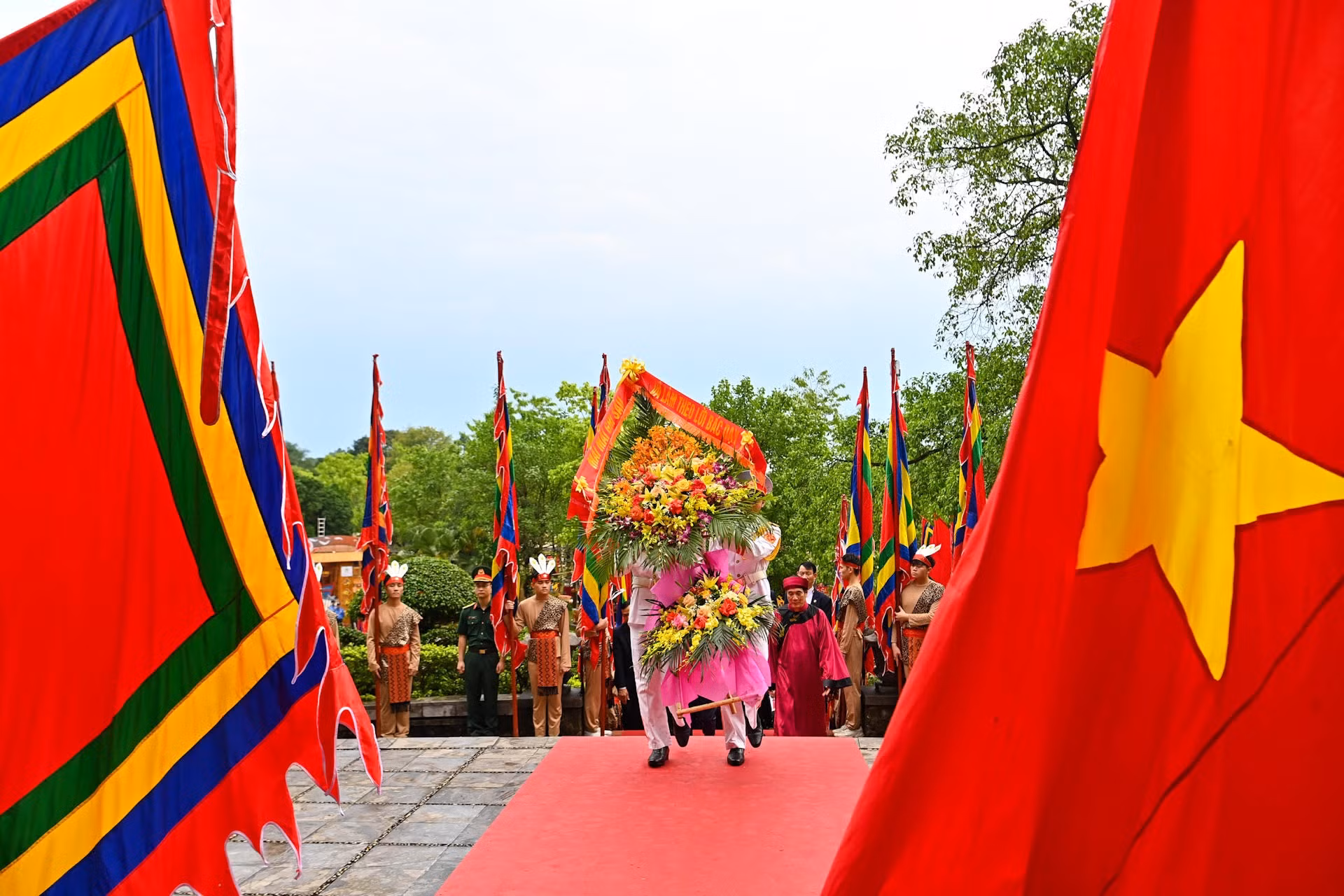 Tiếp đó, các đồng chí lãnh đạo Đảng, Nhà nước cùng các đại biểu đặt vòng hoa, thành kính tưởng niệm Chủ tịch Hồ Chí Minh và các chiến sĩ đã hy sinh vì Tổ quốc bên Bức phù điêu có hình tượng Bác Hồ nói chuyện với cán bộ, chiến sĩ Đại đoàn quân Tiên Phong tại ngã năm Đền Giếng.