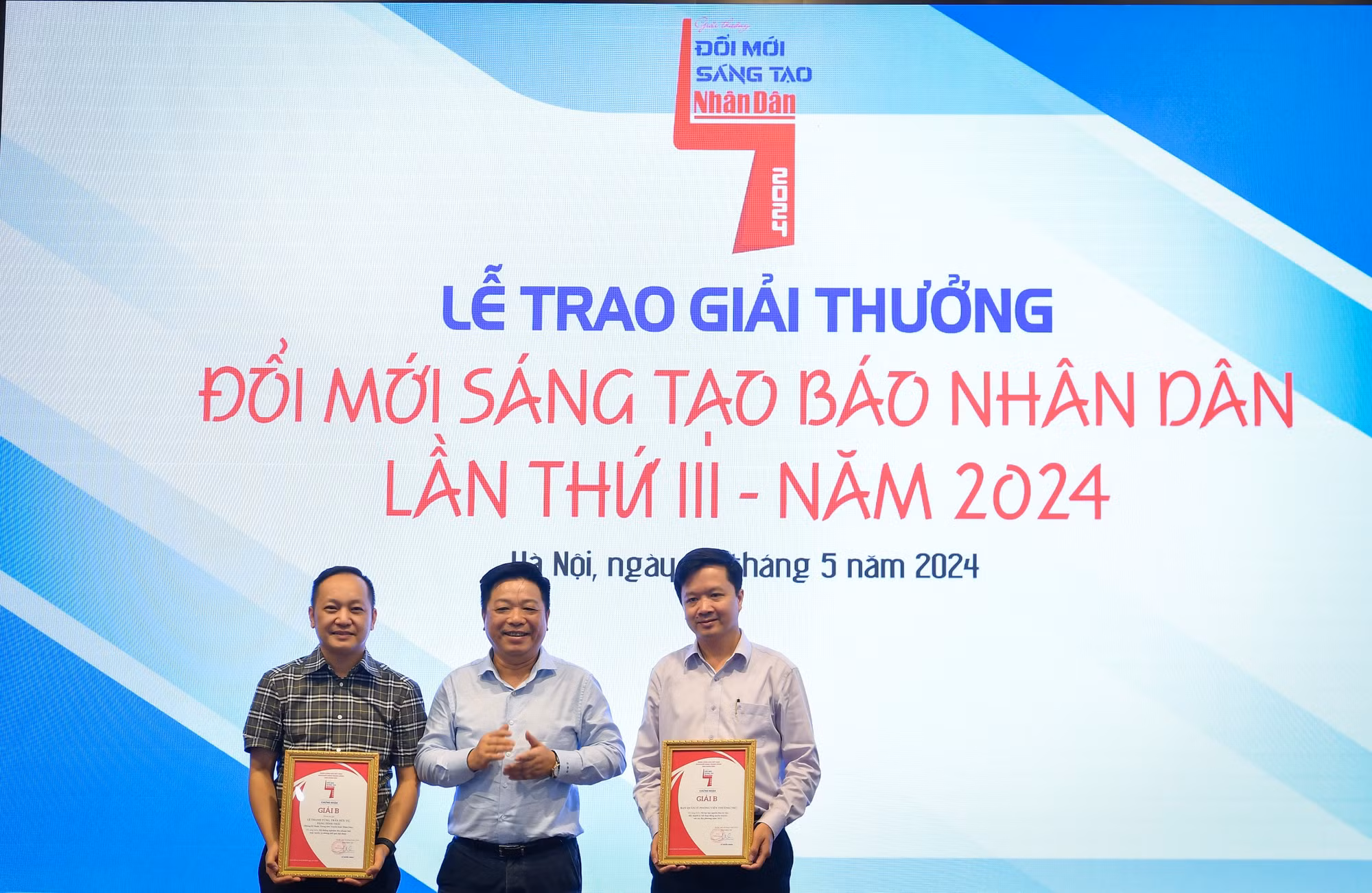 Đồng chí Quế Đình Nguyên, Phó Bí thư Đảng ủy, Phó Tổng Biên tập Báo Nhân Dân trao giải B cho đại diện các đơn vị, nhóm tác giả.
