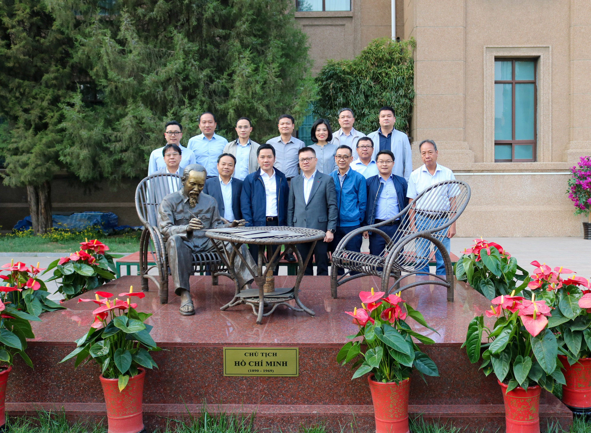 Đoàn đại biểu Báo Nhân Dân cùng đại diện lãnh đạo Đại sứ quán chụp ảnh lưu niệm tại tượng Bác Hồ trong khuôn viên Đại sứ quán.