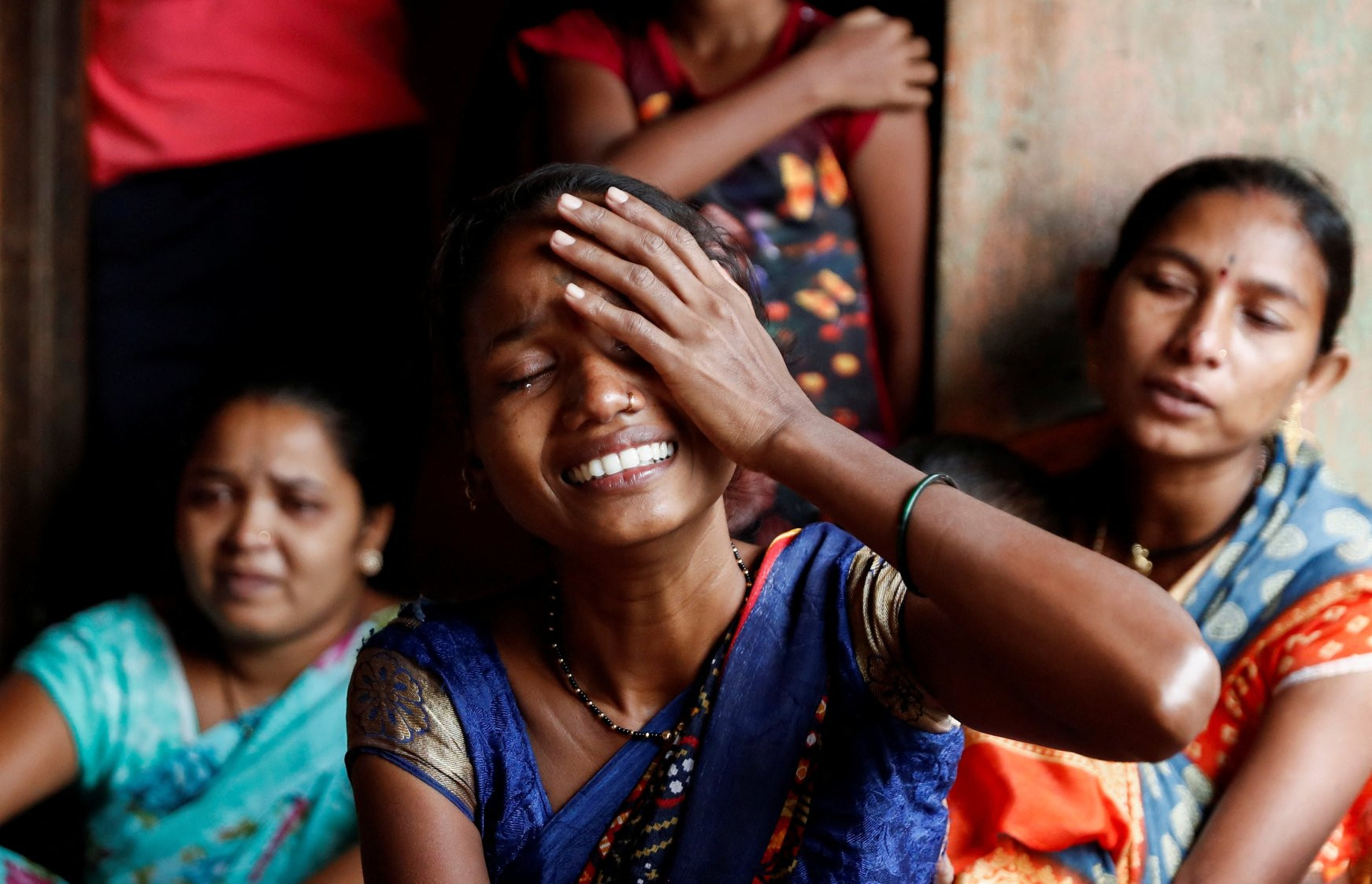 Những người phụ nữ thương tiếc cái chết của người thân sau trận lở đất tại một ngôi làng ở Raigad, bang Maharashtra, miền tây Ấn Độ. Ảnh: Reuters.