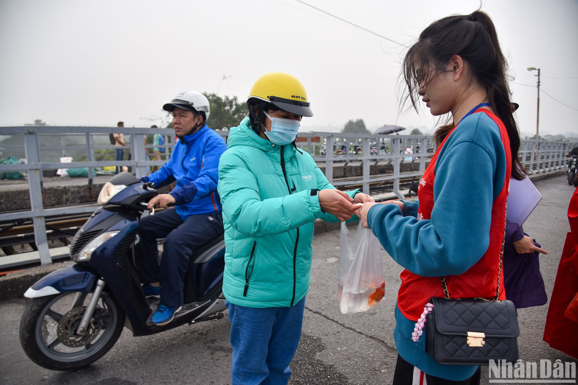 Người dân tới phóng sinh cá được các bạn tình nguyện viên hướng dẫn tận tình giúp đỡ.