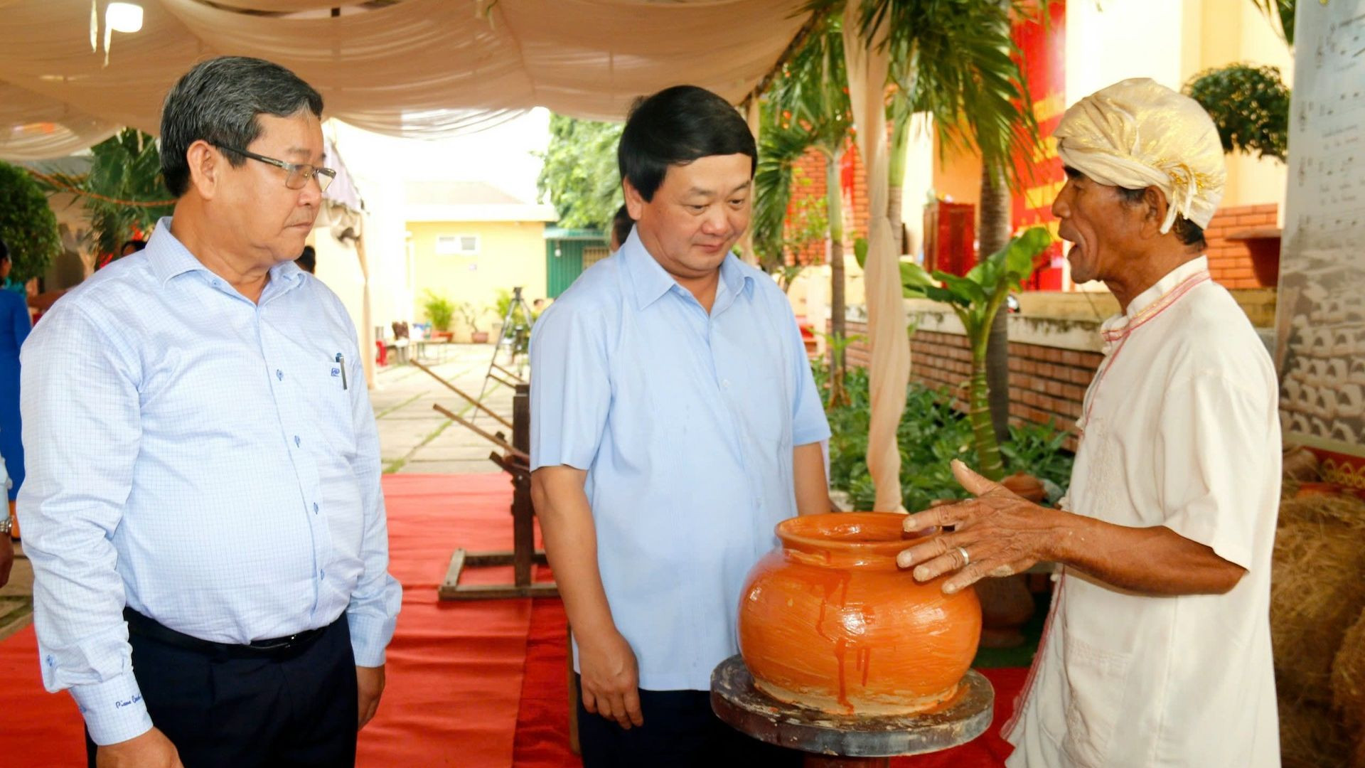 Đồng chí Hầu A Lềnh, Bộ trưởng, Chủ nhiệm Ủy ban Dân tộc (giữa) tìm hiểu cách làm gốm của người Chăm.