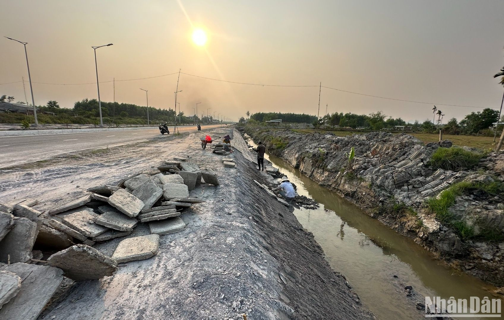 Các nhân công đang hoàn thiện các hạng mục cuối của dự án như gia cố taluy dương, xử lý nước ngầm và sạt trượt, hoàn thành bó vỉa đối với đoạn vừa thi công xong phần nền đường.