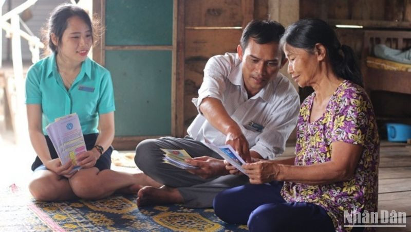 Vận động người dân tham gia bảo hiểm y tế. (Ảnh: Tâm Trung)