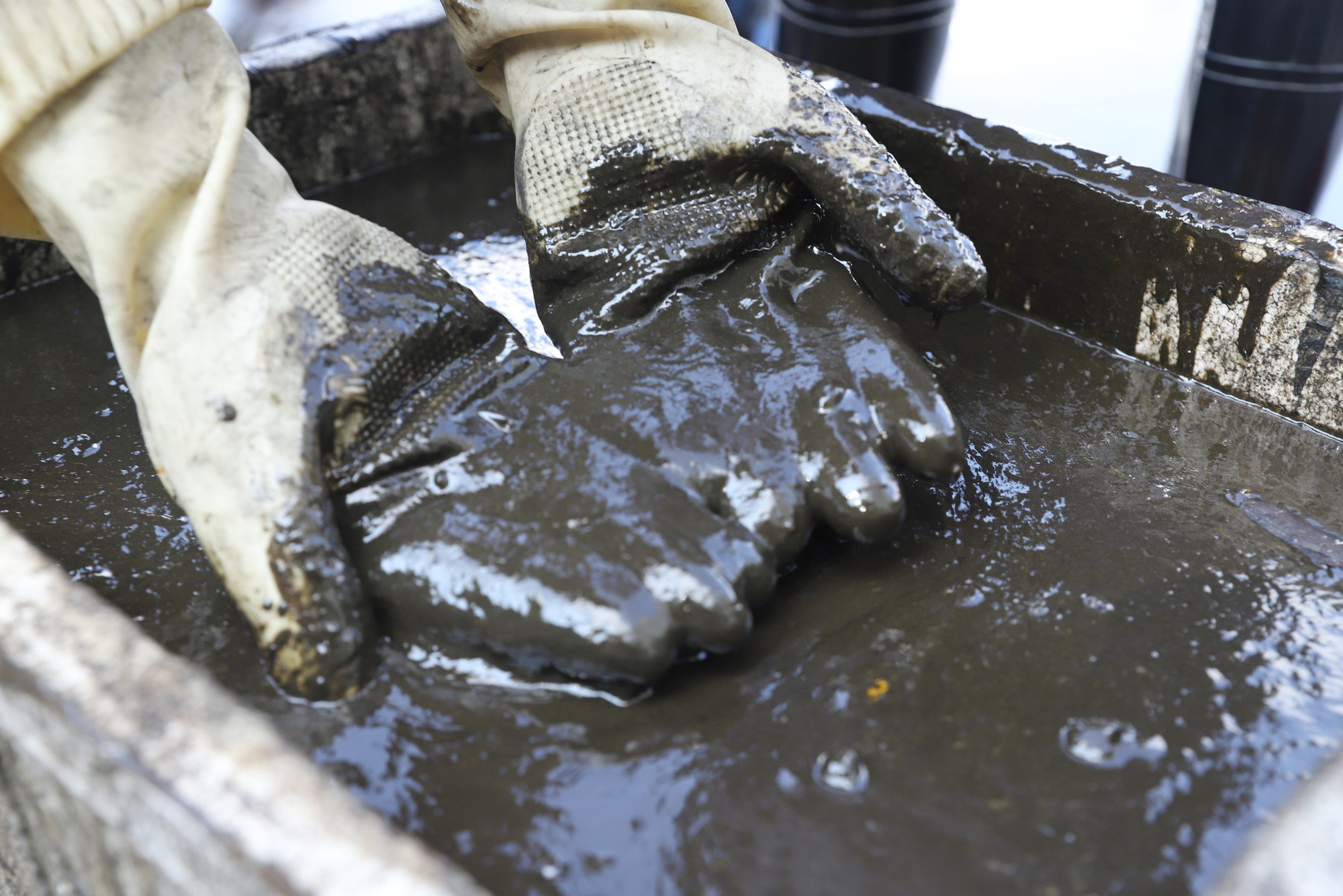 Dầu thải đặc quánh trong các xô chứa.