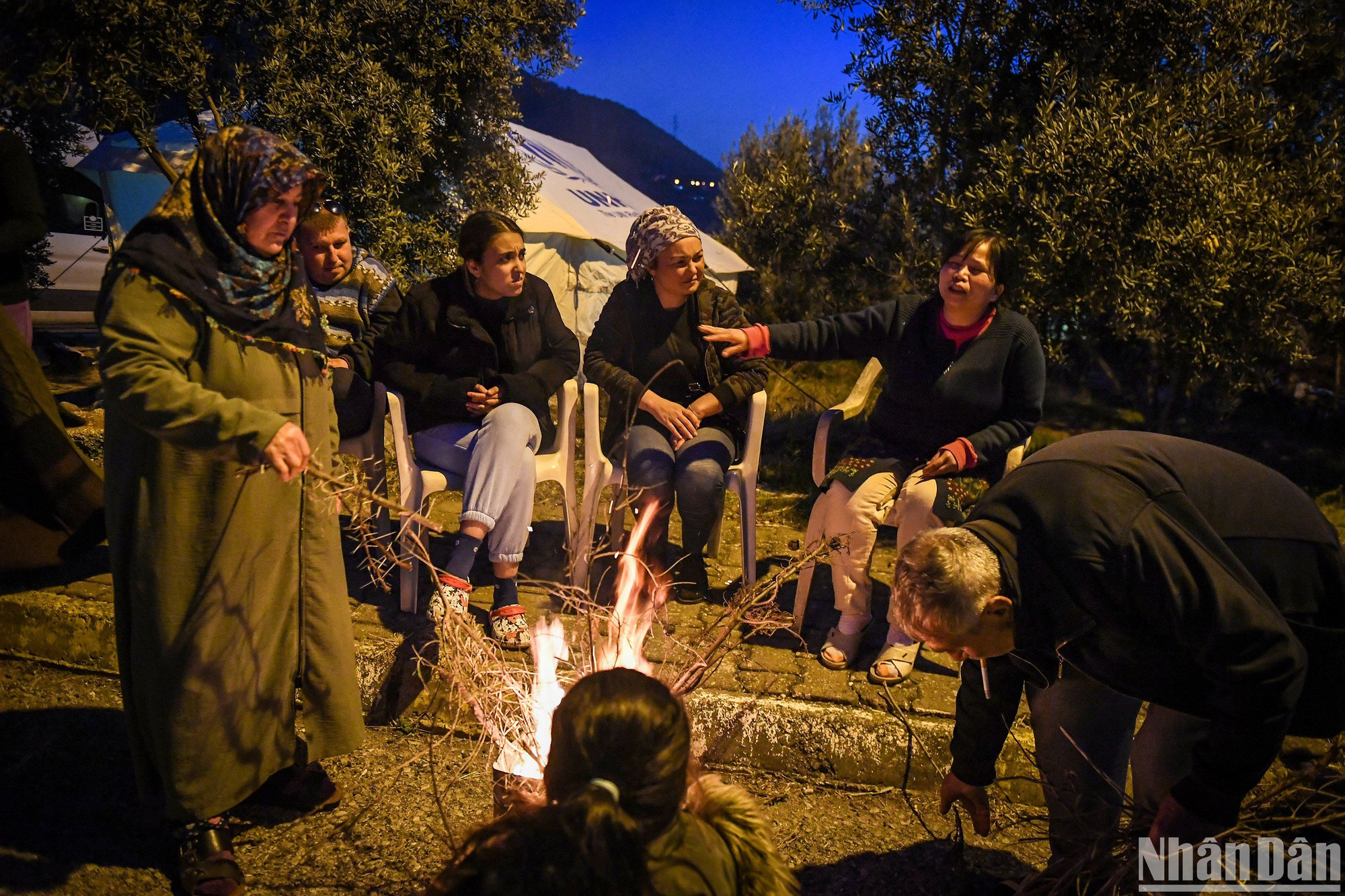 Người dân đốt lửa sưởi ấm cùng nhau trong đêm. Họ e ngại về chính căn nhà của mình vì lý do an toàn. (Ảnh: Thành Đạt)
