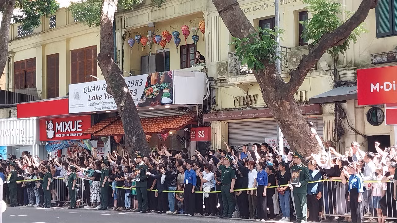 Người dân đứng ngay ngắn trên phố Hàng Khay chờ đoàn xe chở linh cữu của Tổng Bí thư Nguyễn Phú Trọng. (Ảnh: THANH NGA)