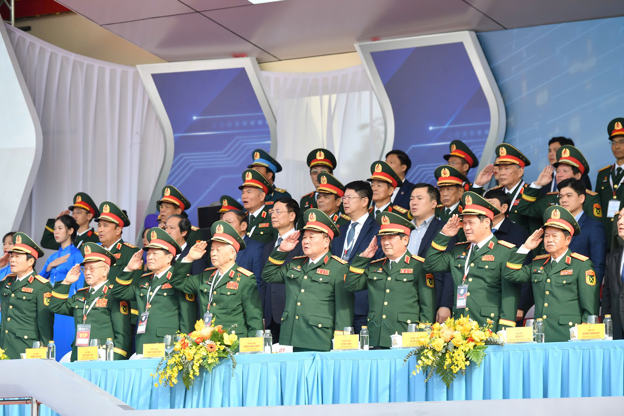 Các đồng chí lãnh đạo Đảng, Nhà nước và các đại biểu thực hiện nghi lễ chào cờ tại Lễ khai mạc.