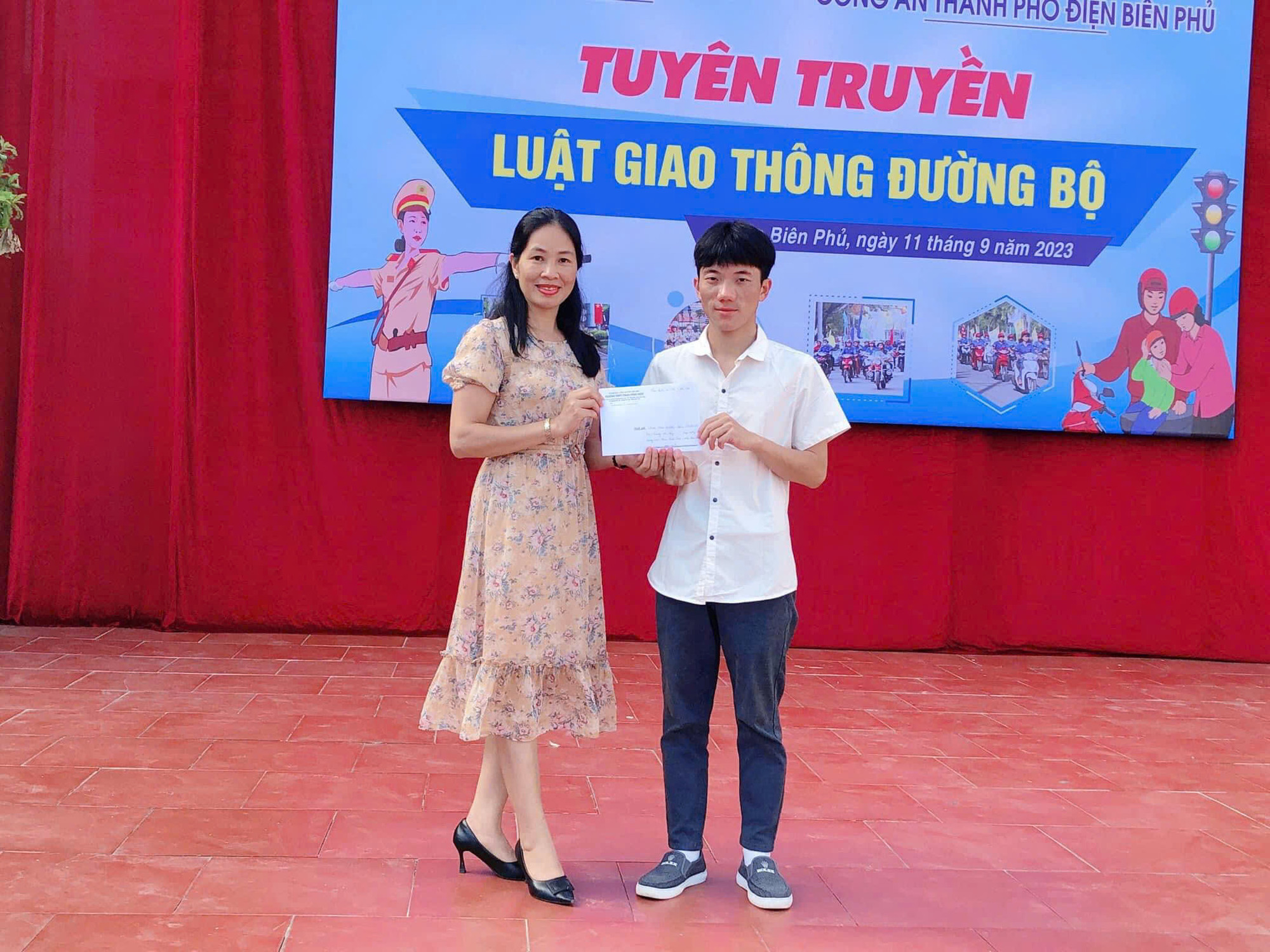 Cô Nguyễn Thị Hà (bên trái) trao học bổng cho học sinh. (Ảnh: NVCC)