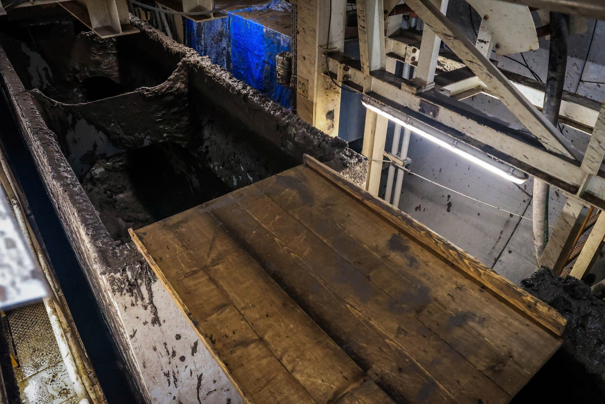 Bùn thải, chủ yếu là đất sét, được đổ đầy các khoang xe thông qua hệ thống ống dẫn trước khi được vận chuyển đi.