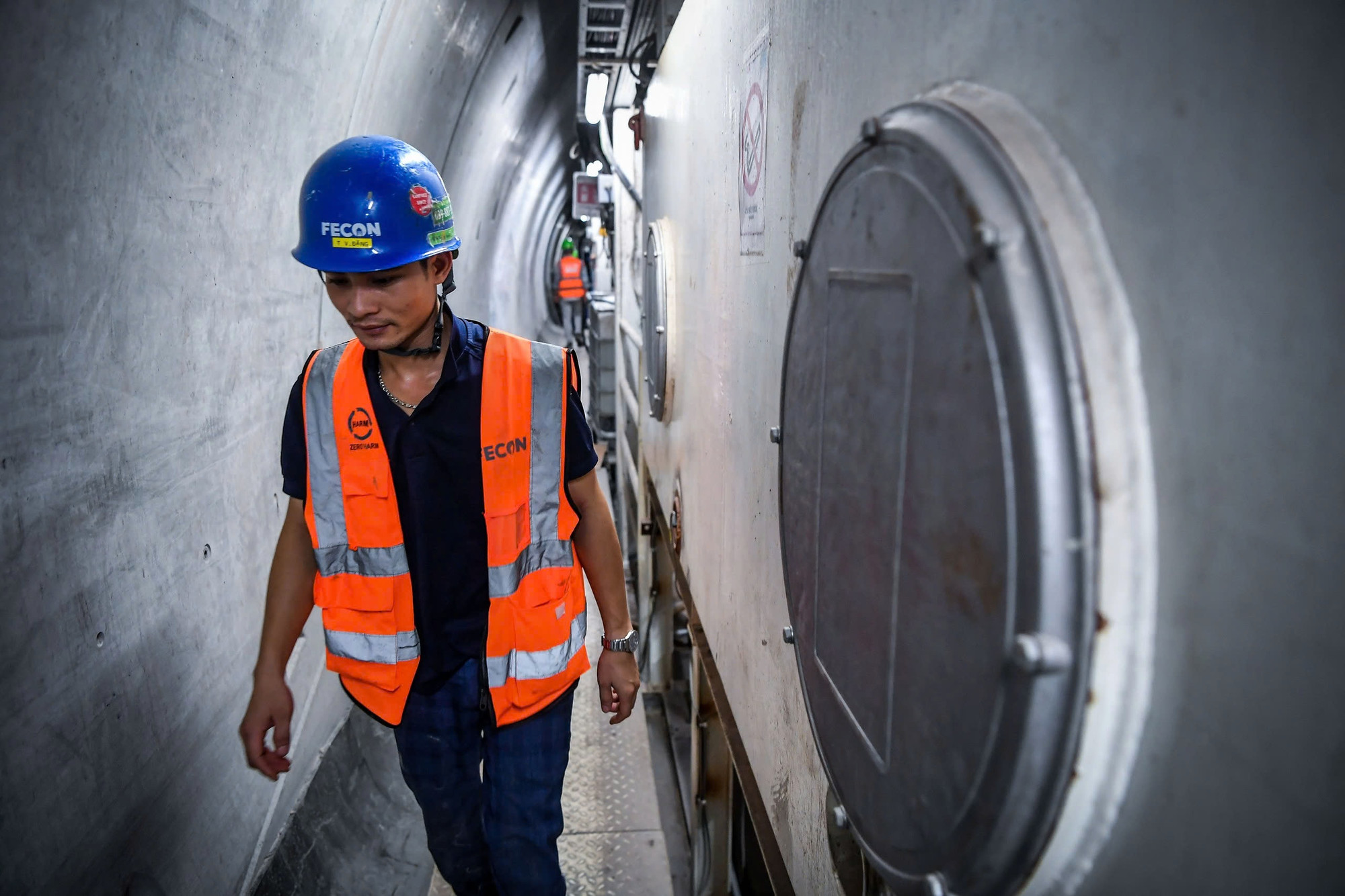 Cán bộ công nhân viên di chuyển dọc theo các hành lang hẹp. Họ phải tuân thủ nghiêm ngặt các quy định về an toàn, trang phục và rất nhiều yêu cầu đặc thù khác.