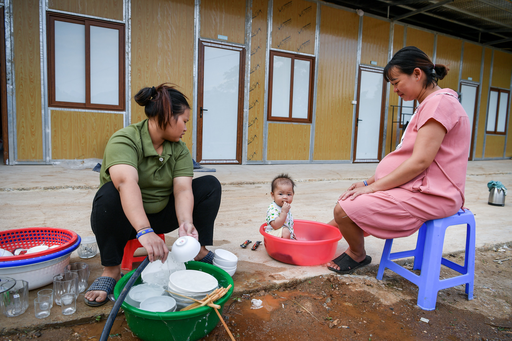 Bốn dãy nhà tạm cư gồm 23 căn nằm trên bãi đất rộng hơn 2.000m2. Phòng nằm cạnh nhau, chung khoảnh sân, đầu hồi trồng hoa giấy. Trước cửa mỗi nhà đều gắn tên chủ hộ.