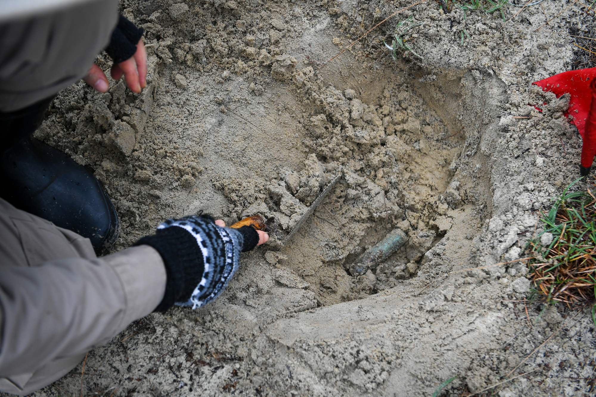 Sau những thao tác thận trọng, một vật nổ cũng lộ ra dưới lớp cát. Vị trí vật nổ nằm chỉ cách mặt đất chừng 20cm.