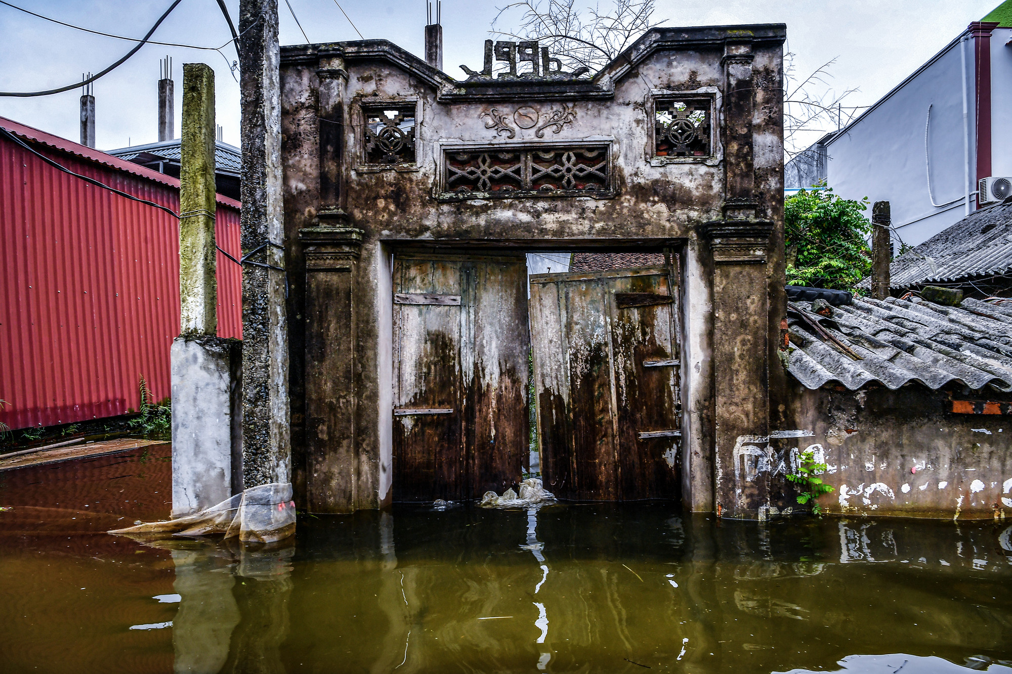 Tại xóm 4, nước ngập sâu nhất, ở mức khoảng 1,5m. Trong ảnh, nước đã dâng quá nửa cổng một căn nhà của người dân. Tại xóm 4, nước ngập sâu nhất, ở mức khoảng 1,5m. Trong ảnh, nước đã dâng quá nửa cổng một căn nhà của người dân.