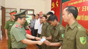 Đồng chí Giám đốc Công an tỉnh Sơn La trao quà cho các cá nhân và tập thể.