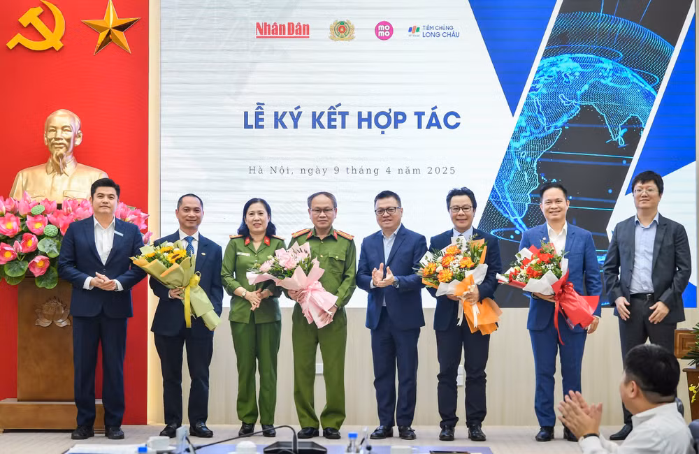 Tổng Biên tập Báo Nhân Dân Lê Quốc Minh tặng hoa cho các đại biểu.