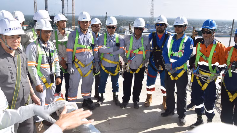 Lãnh đạo địa phương, cán bộ và công nhân đơn vị thi công trao đổi trước khi căng dây cáp đầu tiên cho cầu Rạch Miễu 2.