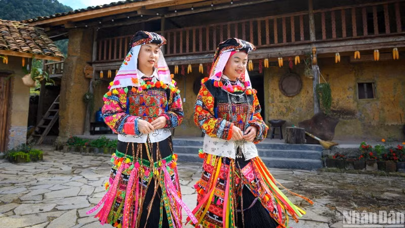 Người Lô Lô Hoa ở chân núi Rồng, thuộc xã Lũng Cú, huyện Đồng Văn, tỉnh Hà Giang bên kiến trúc nhà trình tường lợp ngói đặc trưng. (Ảnh minh họa: THÀNH ĐẠT) 