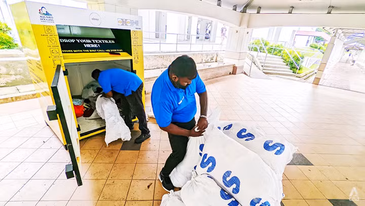 Nhân viên LifeLine thu gom quần áo trong các thùng rác tái chế. Ảnh: CHANNEL NEWS ASIA