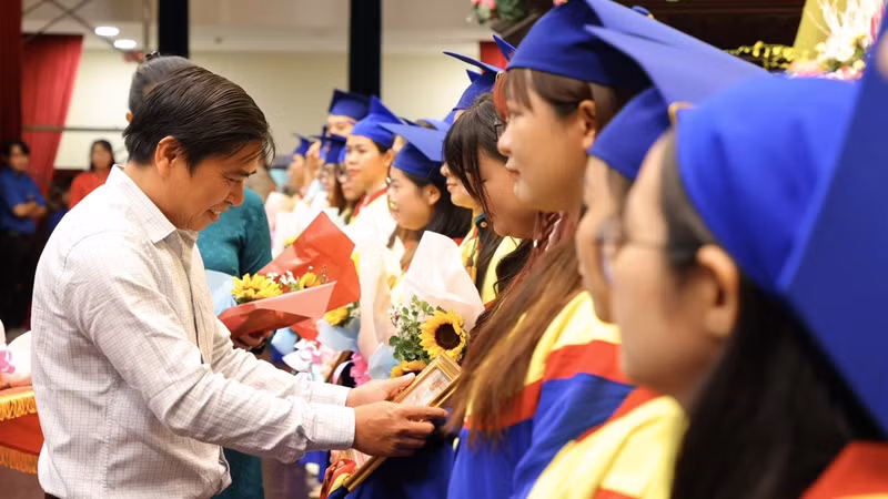 Tiến sĩ Phạm Vũ Quốc Bình, Phó Tổng Cục trưởng Tổng cục Giáo dục nghề nghiệp (Bộ Lao động-Thương binh và Xã hội) khen thưởng cho sinh viên xuất sắc.