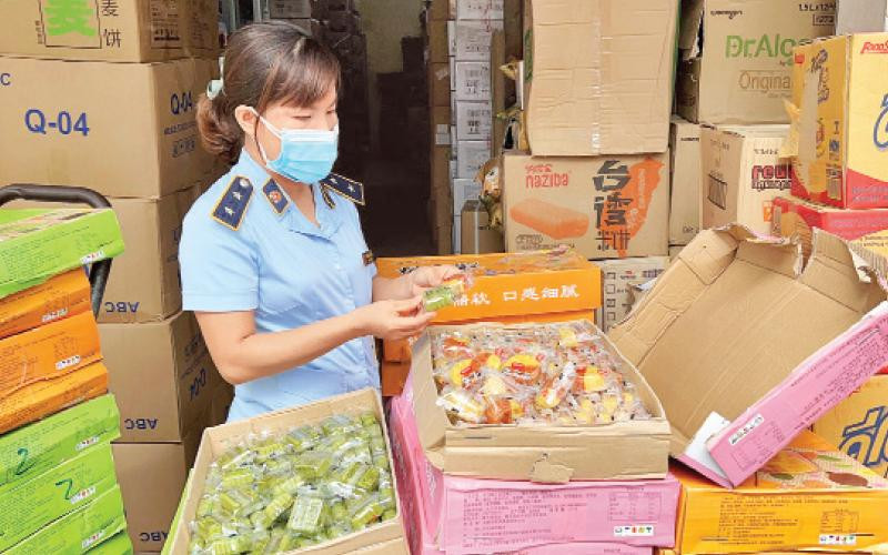 Cán bộ Đội Quản lý thị trường số 24 kiểm tra các sản phẩm bánh Trung thu do nước ngoài sản xuất, nhưng không có hóa đơn, chứng từ tại xã La Phù, huyện Hoài Đức.