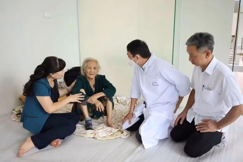 Cán bộ quận Tây Hồ thăm hỏi, chăm sóc sức khỏe người dân ngoài bãi sông di dời vào nơi an toàn.