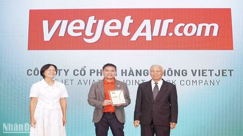 Ông Nguyễn An Di, Giám đốc Nhân sự Vietjet (đứng giữa) nhận giải thưởng tôn vinh 50 doanh nghiệp phát triển bền vững từ ban tổ chức.
