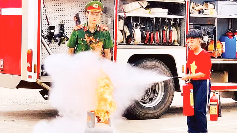 Các em học sinh rèn luyện kỹ năng phòng cháy, chữa cháy. 