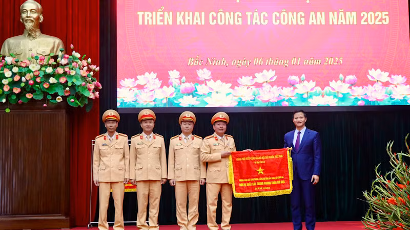 Đồng chí Vương Quốc Tuấn trao Cờ thi đua của Chính phủ tặng Phòng Cảnh sát giao thông, Công an tỉnh.