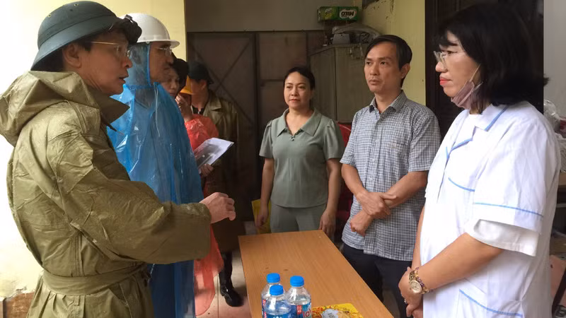 Phó Giám đốc Sở Y tế Vũ Cao Cương trao đổi với các bộ y tế ứng trực chăm sóc sức khỏe cho người dân trên địa bàn quận Ba Đình, thành phố Hà Nội.