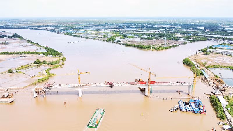 Cầu Gành Hào trên trục tuyến Đông-Tây giúp nối liền bờ biển Đông với bờ biển Tây tỉnh Cà Mau đang trong giai đoạn hoàn thành xây dựng. (Ảnh chụp trước Tết Nguyên đán 2025).