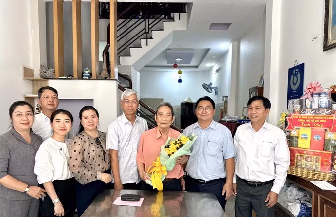 Đồng chí Võ Văn Hoan tặng quà ông Vũ Tiến Đông. Ảnh: CHÍ THẠCH 