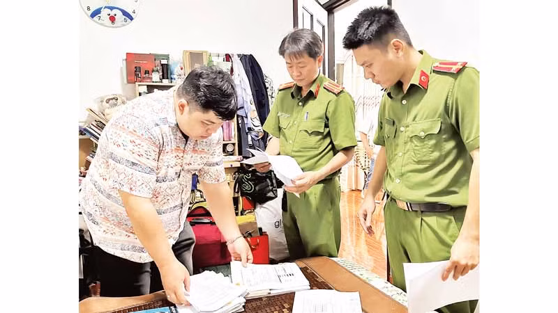 Cơ quan chức năng làm việc với một đối tượng cho vay nặng lãi. (Ảnh CTV)