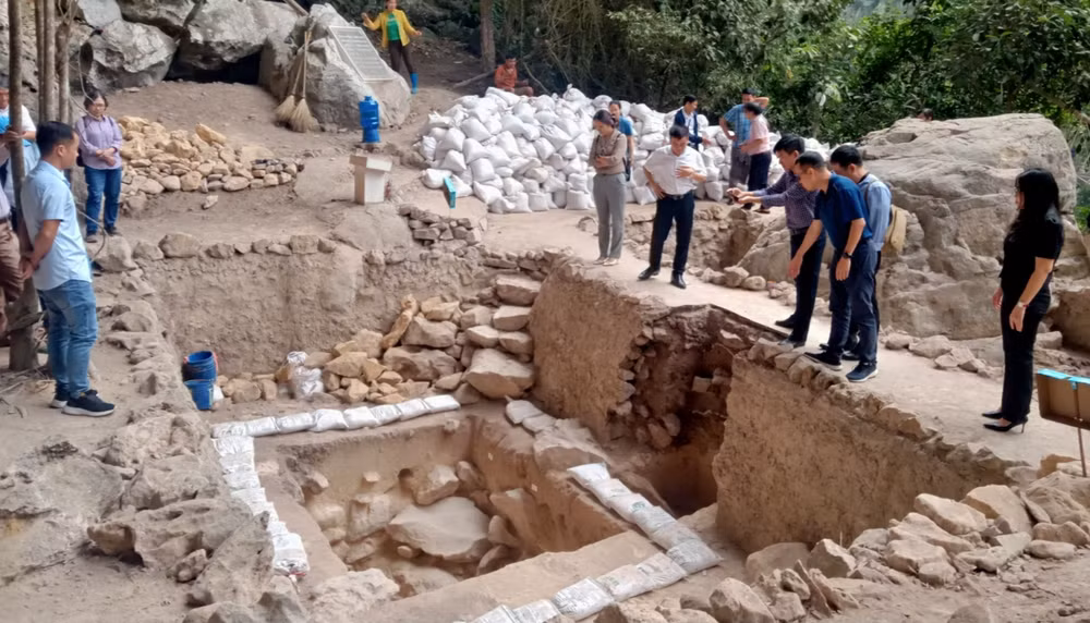 Các nhà khoa học, nhà nghiên cứu, quản lý văn hóa tham quan hố khai quật Mái Đá Ngườm được mở rộng phạm vi sâu, rộng hơn so với khai quật lần thứ 4.