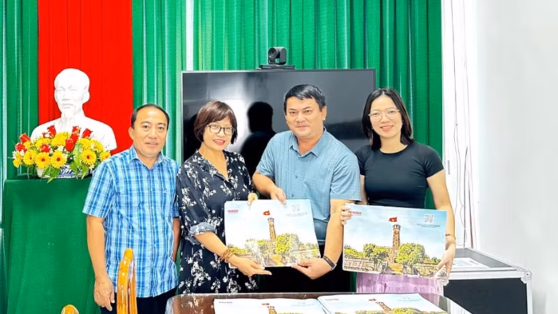 Đại diện Trường phổ thông trung học Bình Thủy nhận ấn phẩm.