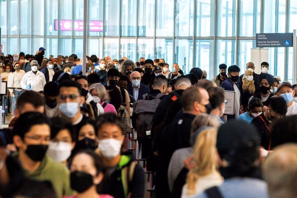 Du khách xếp hàng dài ở cửa ra máy bay tại sân bay quốc tế Toronto Pearson ở Mississauga, Ontario, Canada hôm 20/5 (Ảnh: REUTERS)