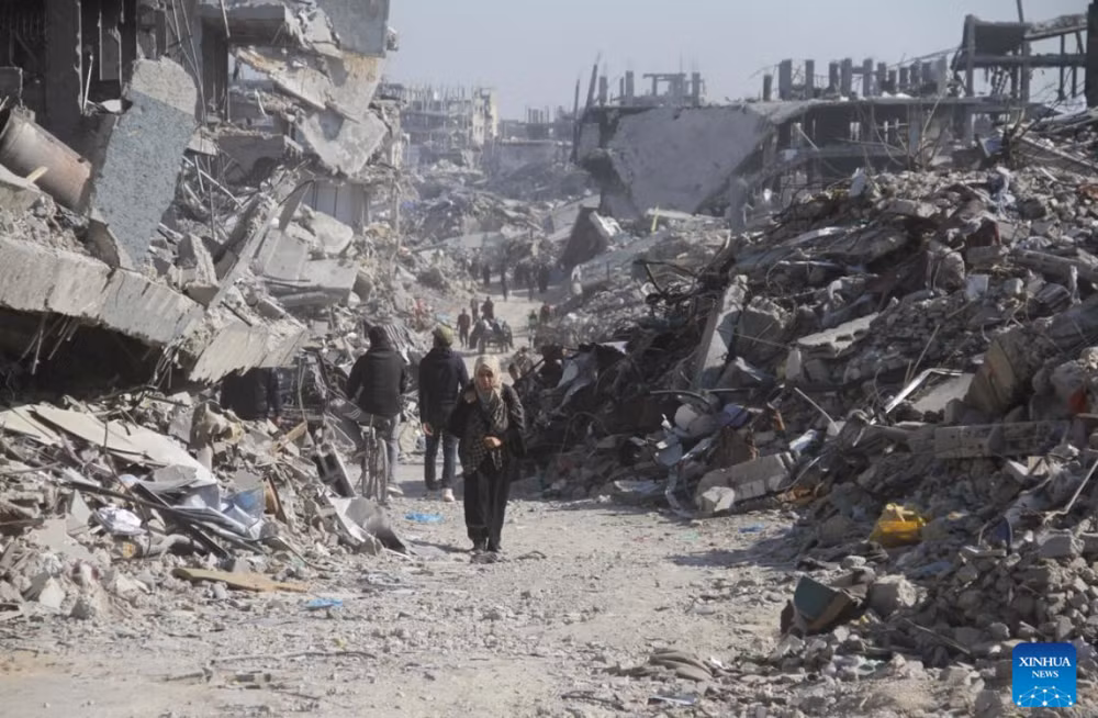 Người dân Palestine trên một con phố có những tòa nhà bị phá hủy tại trại tị nạn Jabalia ở phía bắc Dải Gaza, vào ngày 29/1/2025. Ảnh: Tân Hoa xã.