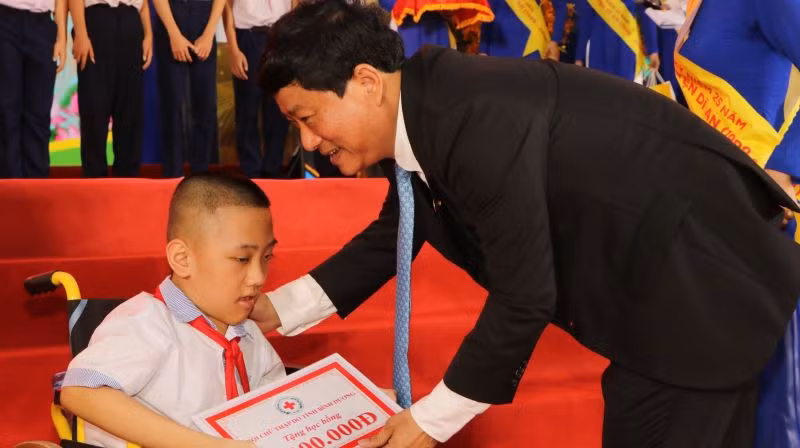 Chủ tịch Ủy ban nhân dân tỉnh Bình Dương Võ Văn Minh trao học bổng cho học sinh có hoàn cảnh khó khăn.