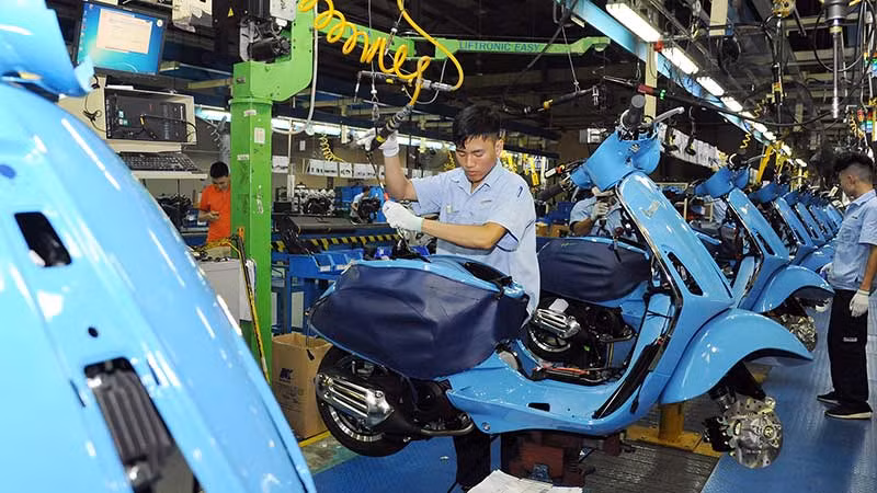 Công nhân Công ty TNHH Piaggio Việt Nam (Khu công nghiệp Bình Xuyên, tỉnh Vĩnh Phúc) sản xuất và lắp ráp xe máy. (Ảnh TRẦN KHÁNH)