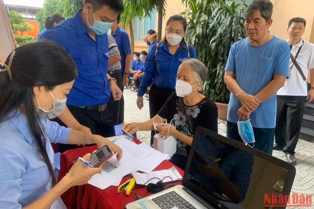 Nhân viên Trung tâm Quản lý Giao thông công cộng Thành phố Hồ Chí Minh hướng dẫn người dân sử dụng thẻ đi xe buýt miễn phí.