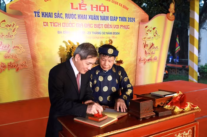 Bí thư Quận ủy Ba Đình Hoàng Minh Dũng Tiến thực hiện nghi thức khai ấn Lý triều Đại Vương “Trấn Tây Thượng Đẳng”. (Ảnh: Phạm Linh)