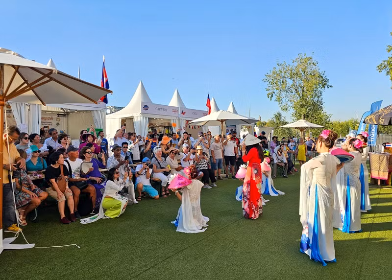 Du khách quốc tế thích thú với tiết mục nghệ thuật dân gian của gian hàng Việt Nam.