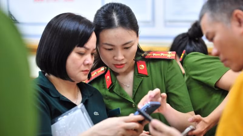 Công an thành phố Hà Nội hướng dẫn người dân tích hợp ứng dụng VNeID. (Ảnh HOÀNG PHONG)