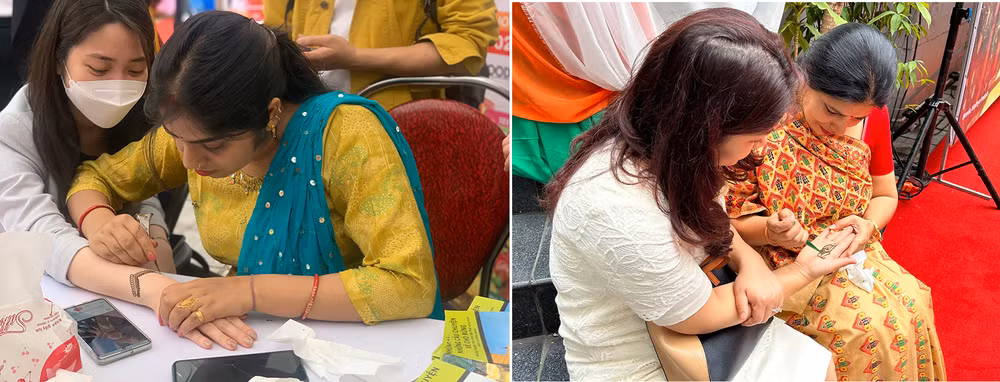 Du khách thích thú trải nghiệm vẽ henna Ấn Độ.