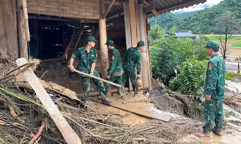 Cán bộ chiến sĩ các lực lượng vũ trang tỉnh Điện Biên hỗ trợ người dân Mường Pồn di chuyển đồ đạc sau lũ quét.