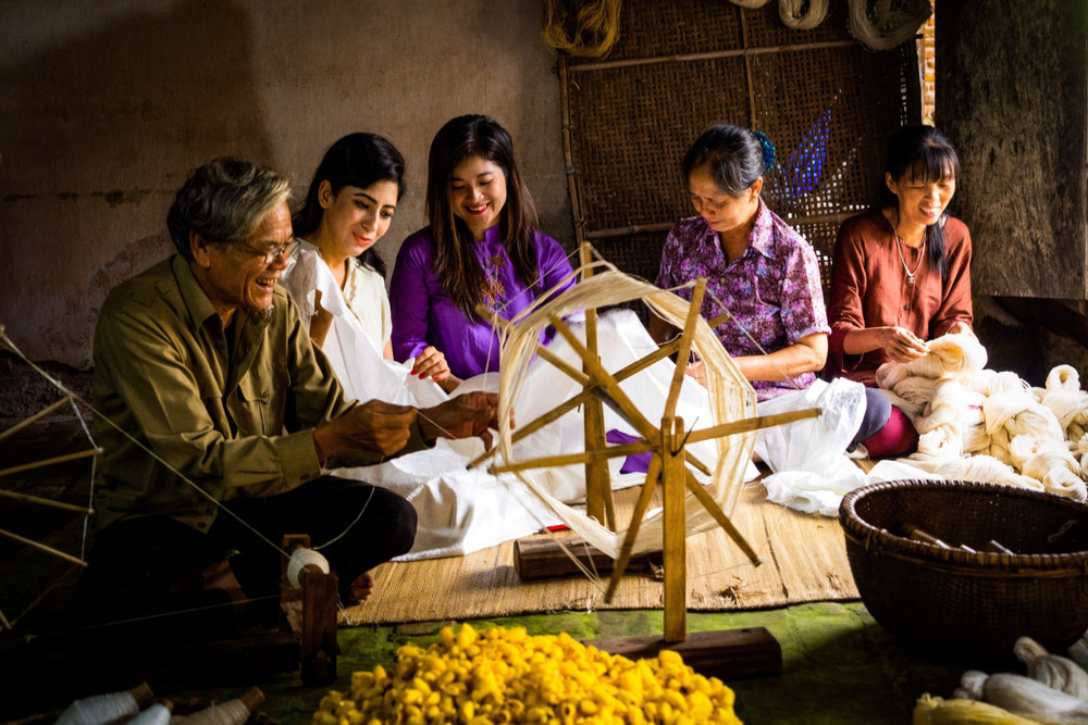 Du khách quốc tế đến làng đũi Nam Cao trải nghiệm quay tơ dệt đũi. Ảnh | Hanhsilk